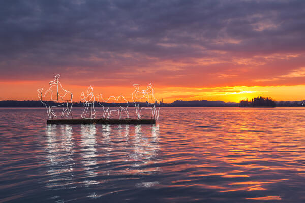 Christmas sunset on Pusiano lake with the lights of floating nativity scene, Pusiano, Brianza, Como province, Lombardy, Italy, Europe