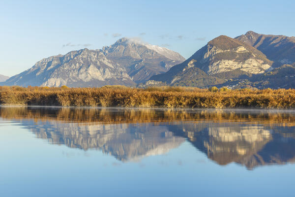 Lecco mountains (Coltignone, San Martino and Grigna) reflected into the Adda river, Airuno, Brianza, Lecco province, Lombardy, Italy, Europe