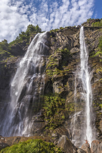 Two people have fun on the rocks, Acqua Fraggia waterfall, Piuro, Sondrio province, Chiavenna valley, Lombardy, Italy, Europe