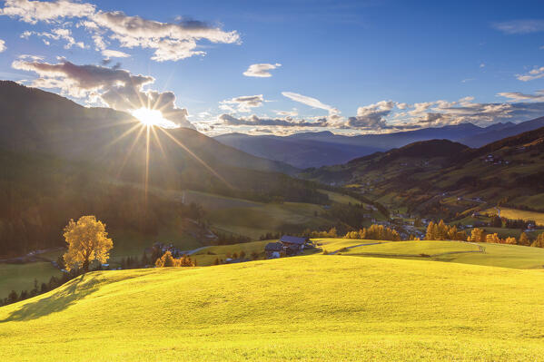 Autumnal sunset on meadows of Funes valley, Santa Magdalena, South Tyrol, Trentino Alto Adige, Bolzano province, Italy, Europe