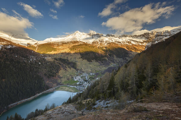 First morning lights on Isola lake and Isola village, Madesimo, Sondrio province, Spluga valley, Lombardy, Italy, Europe
