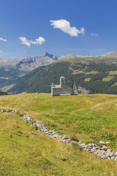 A summer view of San Rocco church in the meadows of the Altopiano degli Andossi, Madesimo, Spluga valley, Sondrio province, Lombardy, Italy, Europe