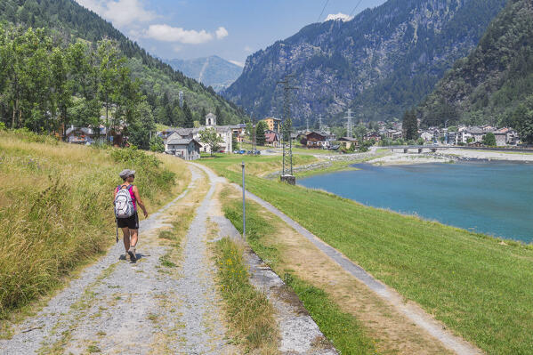 A trekker walking on the ancient Via Spluga path to reach Prestone lake, Campodolcino, Spluga valley, Sondrio province, Lombardy, Italy, Europe (MR)