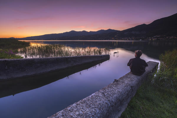 Man watch a sunset on lake Pusiano, Como province, Brianza, Lombardy, Italy, Europe (MR)