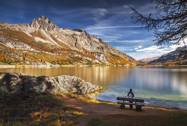 Hiker take relax admiring Lake Sils, Engadine, Canton of Graubunden, Switzerland, Europe (MR)