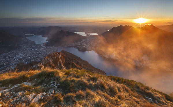 Red and foggy sunset above Lecco, lake Como, Lombardy, Italy, Europe