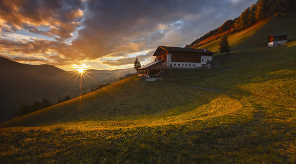 Last ray on a farm in the Funes valley, Coll, Santa Magdalena, South Tyrol region, Trentino Alto Adige, Bolzano province, Italy, Europe