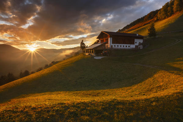 Last ray on a farm in the Funes valley, Coll, Santa Magdalena, South Tyrol region, Trentino Alto Adige, Bolzano province, Italy, Europe