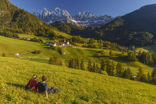 Two brothers admires the village of Santa Magdalena, Funes valley, Odle dolomites, South Tyrol region, Trentino Alto Adige, Bolzano province, Italy, Europetwo (MR)