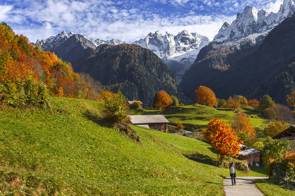Hiker visit the village of Soglio in the Autumn, Maloja region, Canton of Graubunden, Bregaglia valley, Switzerland, Europe (MR)