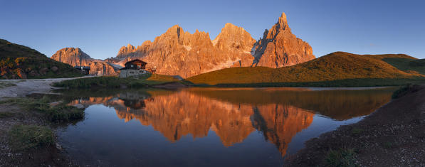 Enrosadira on Pale di San Martino Dolomites reflecting on the lake of Segantini hut, Rolle Pass, Trento province, Trentino Alto Adige, Italy, Europe