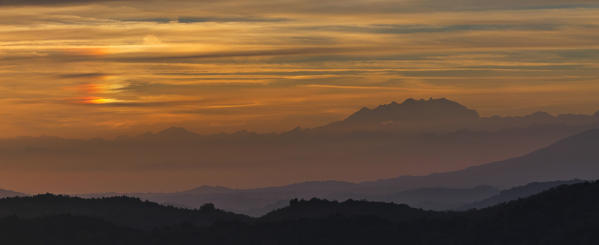 Silhouette of Monte Rosa and sunset with halo (optical phenomenon), Aosta valley, Italy Europe