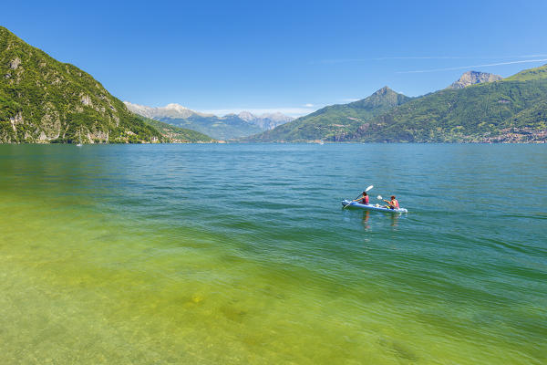 Two guys go canoeing on lake Como, Menaggio, Como province, Lombardy, Italy, Europe