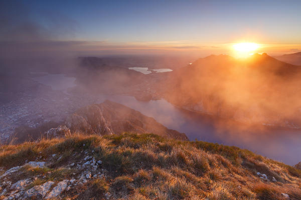 Foggy sunset above Lecco, lake Como, Lombardy, Italy, Europe