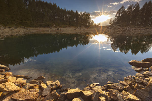Golden rocks at sunset on Lago Azzurro, Campodolcino, Spluga valley, Sondrio province, Lombardy, Italy, Europe