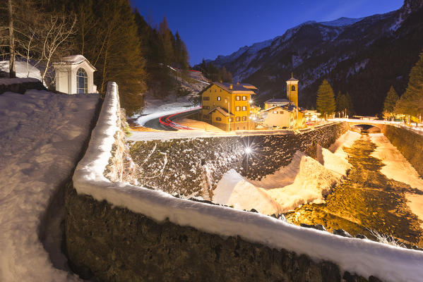 A snowy view of Campodolcino village from Ponte Romano at dusk , Spluga valley, Sondrio province, Lombardy, Italy, Europe