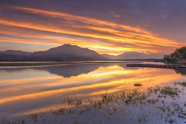 Sunrise on lake Pusiano with fire reflections, Lecco province, Brianza, Lombardy, Italy, Europe