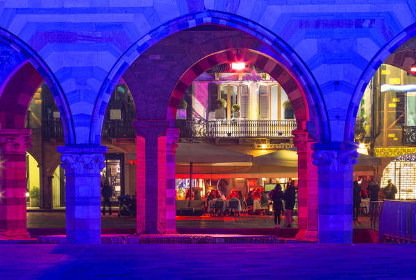 Arches of Broletto palace in Christmas time, Como, Lombardy, Italy, Europe