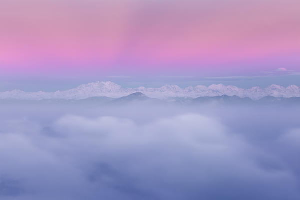 Rosa Mount and other peaks from alps rise up from a sea of clouds at sunrise. View from Brunate town (Como province, Lombardy, Italy, Europe)