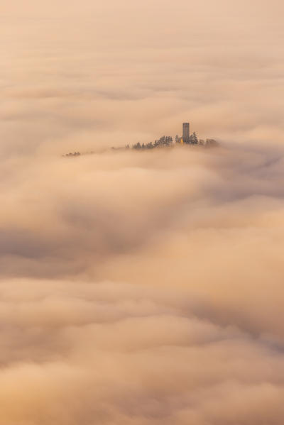 Castel Baradello tower rise up from a sea of clouds at sunrise, Como, Lombardy, Italy, Europe