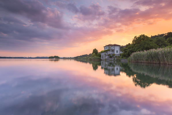 Colors reflections of lake Pusiano at sunset, Pusiano, Como province, Brianza, Lombardy, Italy, Europe