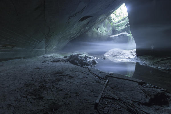 Man takes refuge inside the cave of molera stone, valle del lanza, Malnate, Varese province, Lombardy, Italy, Europe (MR)