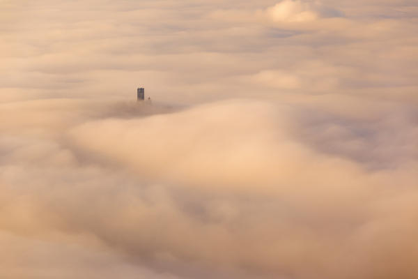 The tower of Castel Baradello rise up from a sea of clouds at sunrise, Como, Lombardy, Italy, Europe