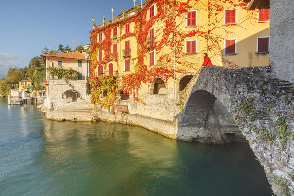 A tourist admire lake Como from Nesso village bridge, Como province, Lombardy, Italy, Europe (MR)