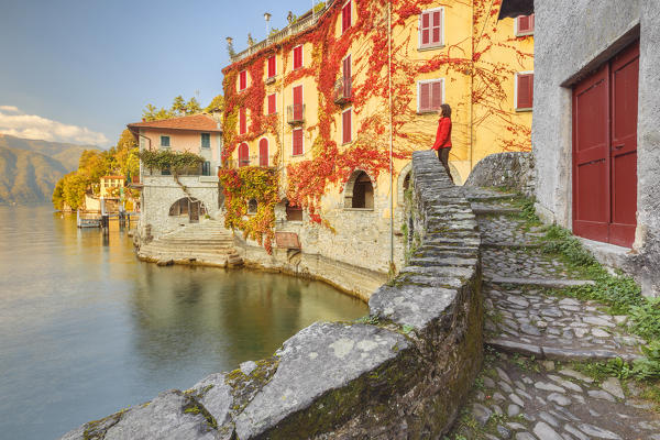 A tourist admire lake Como from Nesso village bridge, Como province, Lombardy, Italy, Europe (MR)