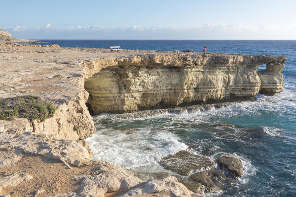 Cyprus, Ayia Napa, woman standing alone on cliff at the sea caves of Cape Greco