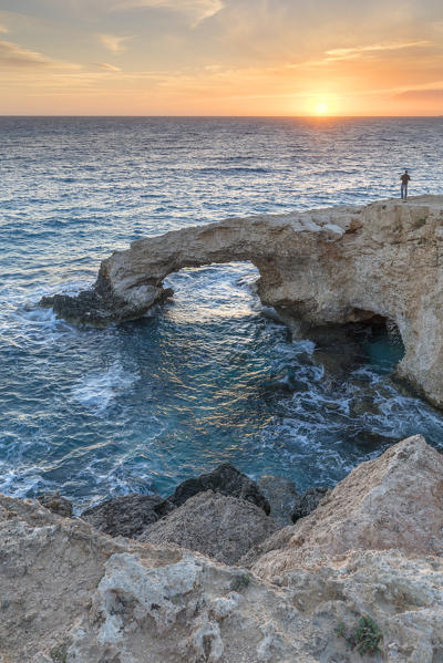 Cyprus, Ayia Napa, Cape Greco, man at sunset standing over the Love Bridge 
