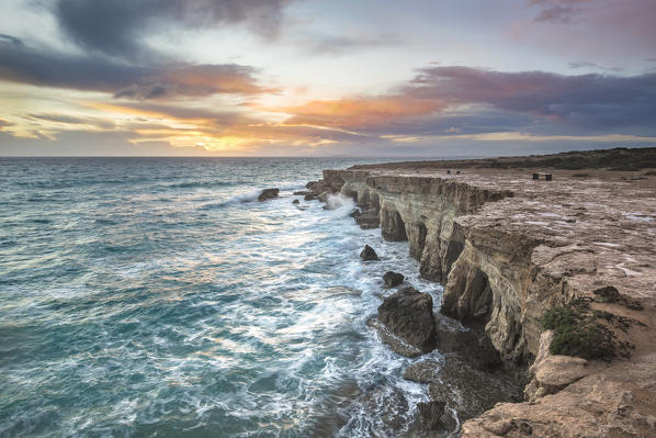Cyprus, Ayia Napa, The sea caves at Cape Greco at sunset 
