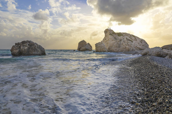 Cyprus, Paphos, Petra tou Romiou also known as Aphrodite’s Rock, boys at the sunset standing over the rock
