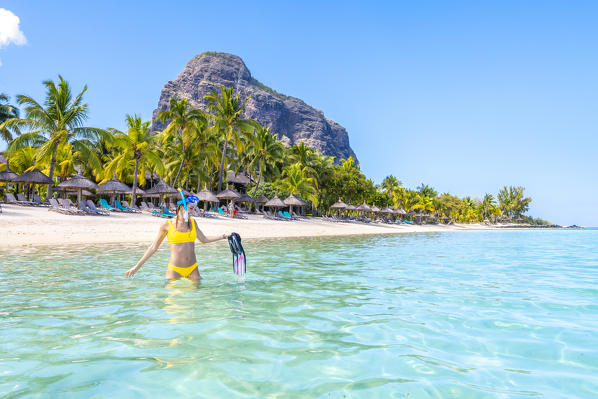 A Young woman with mask and fins at Le Morne Beach. Le Morne Brabant Peninsula, Black River (Riviere Noire), Mauritius, Africa (MR)