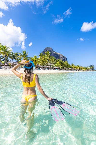A Young woman with mask and fins at Le Morne Beach. Le Morne Brabant Peninsula, Black River (Riviere Noire), Mauritius, Africa (MR)
