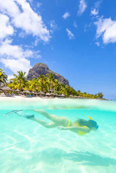 Underwater view of a young woman swimming in Le Morne bay. Le Morne Brabant Peninsula, Black River (Riviere Noire), Mauritius, Africa (MR)