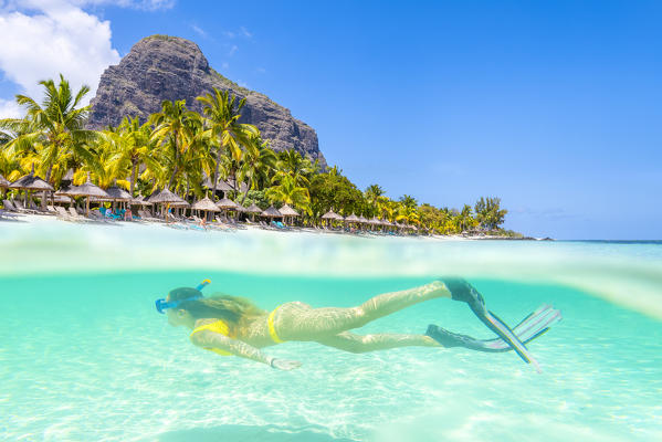 Underwater view of a young woman swimming in Le Morne bay. Le Morne Brabant Peninsula, Black River (Riviere Noire), Mauritius, Africa (MR)