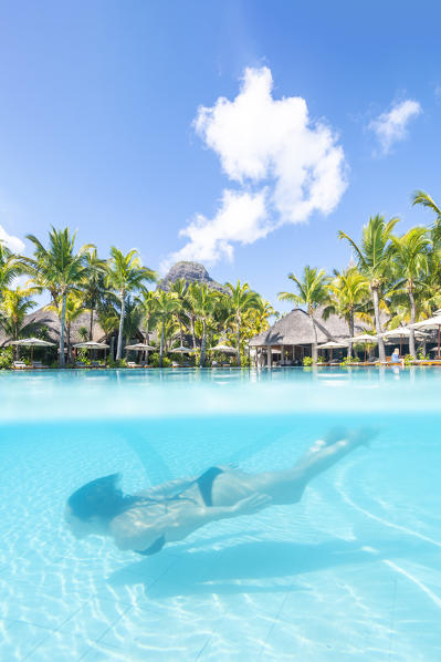 Underwater view of a woman swimming in the pool of the Beachcomber Paradis Hotel, Le Morne Brabant Peninsula, Black River (Riviere Noire), Mauritius (MR) (PR)