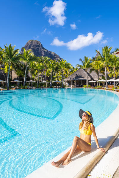 A young woman relaxing in the swimming pool of the Beachcomber Paradis Hotel, Le Morne Brabant Peninsula, Black River (Riviere Noire), Mauritius (MR) (PR)