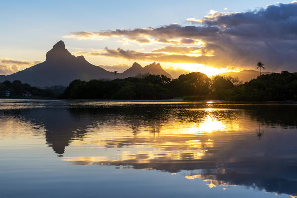 Rempart mountain reflected in Tamarin bay at sunrise. Tamarin, Black River (Riviere Noire), Mauritius, Africa