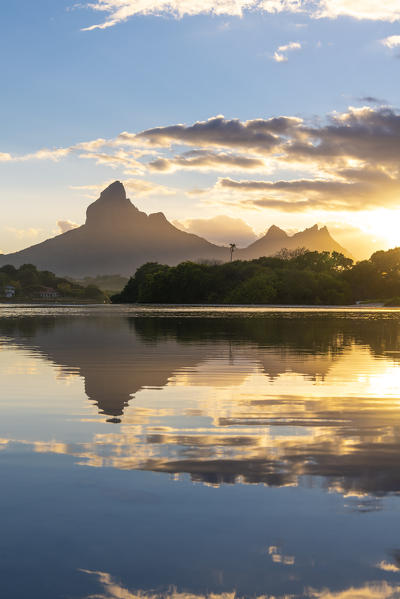 Rempart mountain reflected in Tamarin bay at sunrise. Tamarin, Black River (Riviere Noire), Mauritius, Africa