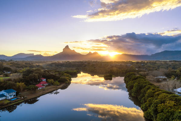 Aerial view of Tamarin bay with Rempart mountain in the background, during the sunrise. Tamarin, Black River (Riviere Noire), West coast, Mauritius, Africa