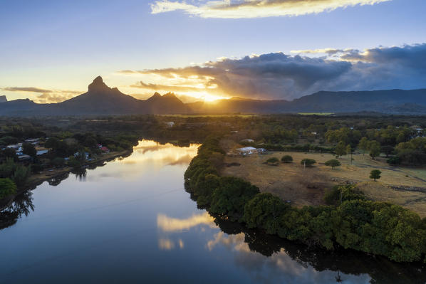 Aerial view of Tamarin bay with Rempart mountain in the background, during the sunrise. Tamarin, Black River (Riviere Noire), West coast, Mauritius, Africa