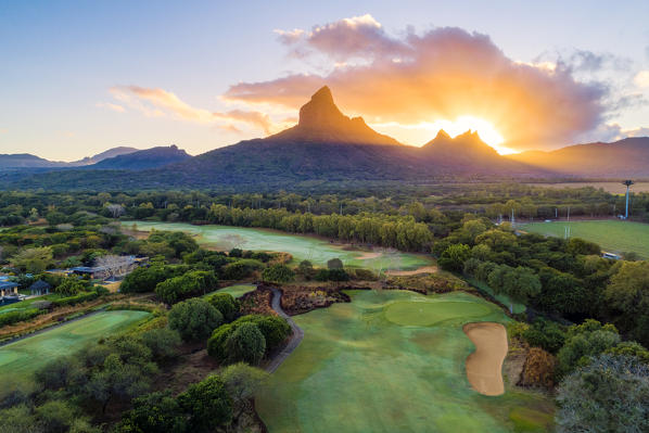 Aerial view of Tamarina golf course with Rempart mountain and Trois mamelles mountain during the sunrise. Tamarin, Black River (Riviere Noire), West coast, Mauritius, Africa