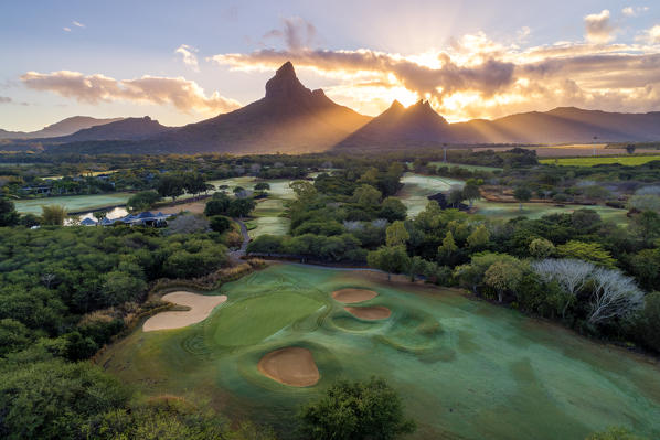 Aerial view of Tamarina golf course with Rempart mountain and Trois mamelles mountain during the sunrise. Tamarin, Black River (Riviere Noire), West coast, Mauritius, Africa