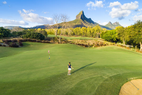 Aerial view of a woman playing golf. Tamarina golf club, Tamarin, Black River (Riviere Noir), Mauritius, Africa