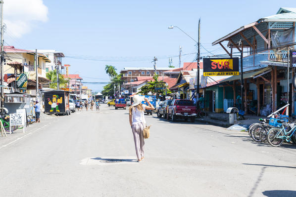 Tourist walks trough the streets of Bocas Town. Bocas Del Toro, Panama, Central America