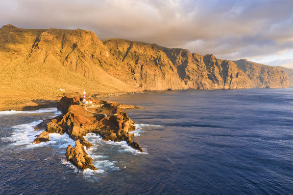 Punta de Teno lighthouse at sunset. Acantilados de Los Gigantes (cliffs) in background. Gran Canaria, Canary Islands, Spain