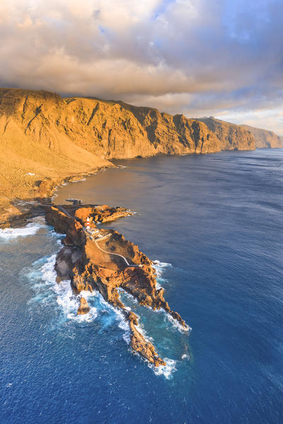 Punta de Teno lighthouse at sunset. Acantilados de Los Gigantes (cliffs) in background. Gran Canaria, Canary Islands, Spain