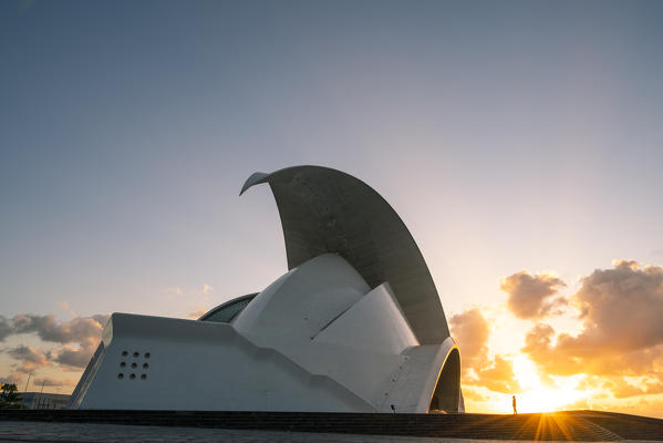 Auditorio de Tenerife at sunrise. Santa Cruz de Tenerife, Tenerife, Canary Islands, Spain. A tourist admiring the view